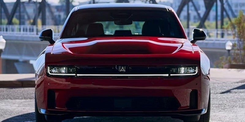 Front view of a dark red Dodge Charger, featuring a full-width LED light bar and the Fratzog logo