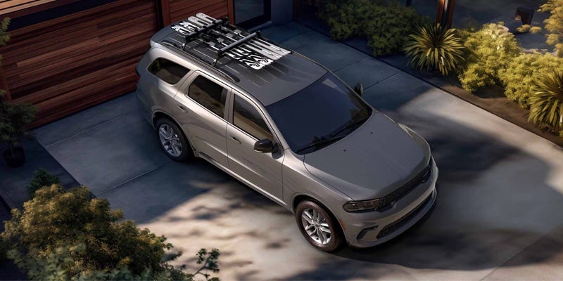 A silver SUV is parked in a residential driveway, viewed from an elevated angle